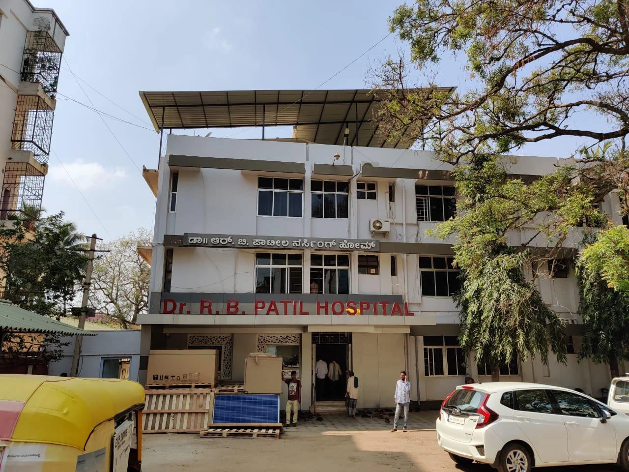 Front of Dr. R. B. Patil Hospital with an elevated solar structure on the roof