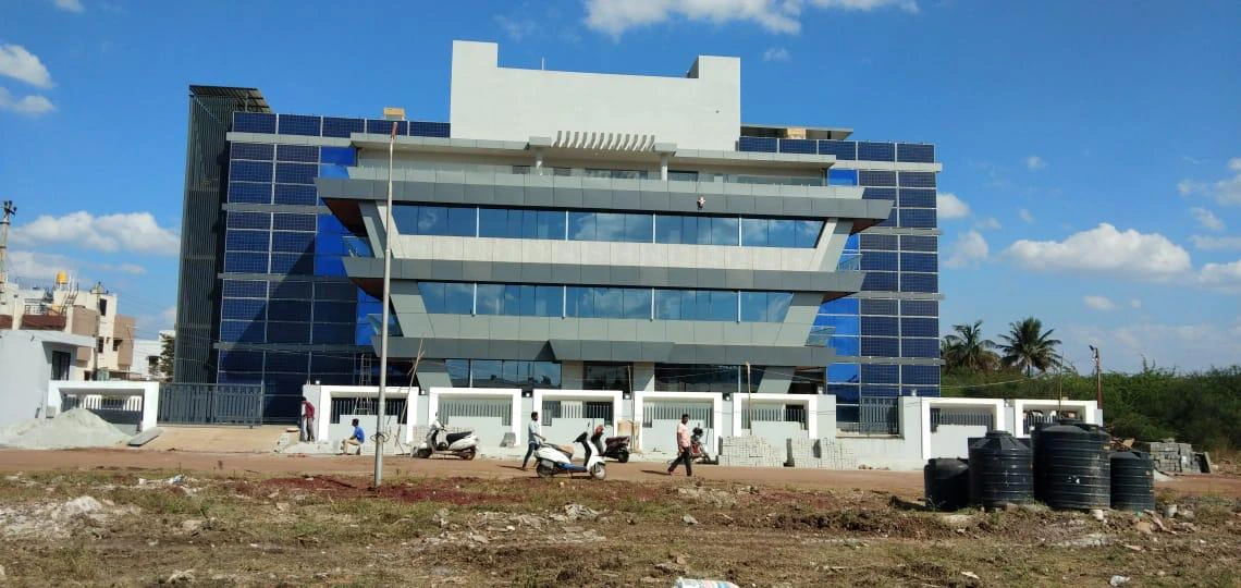 Multi-storey office building with wall-integrated solar panels across the facade
